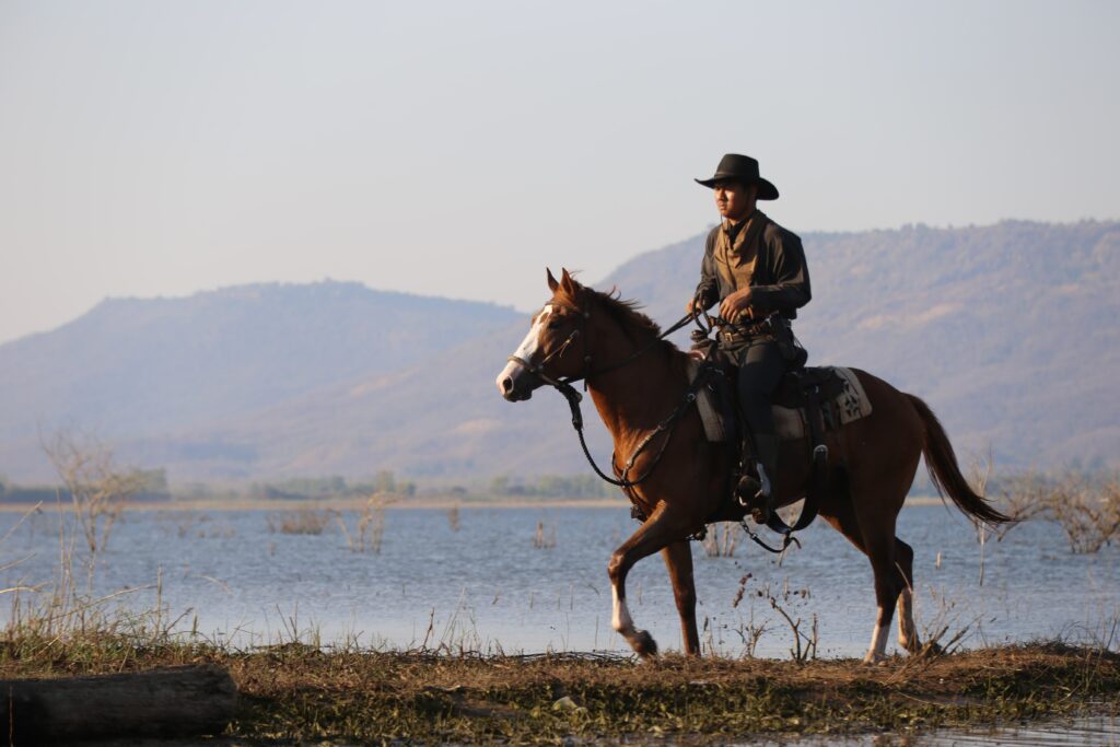 man-riding-horse-lake-min